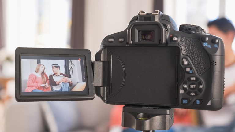 Young couple talking to camera on screen. Woman and man recording a video blog